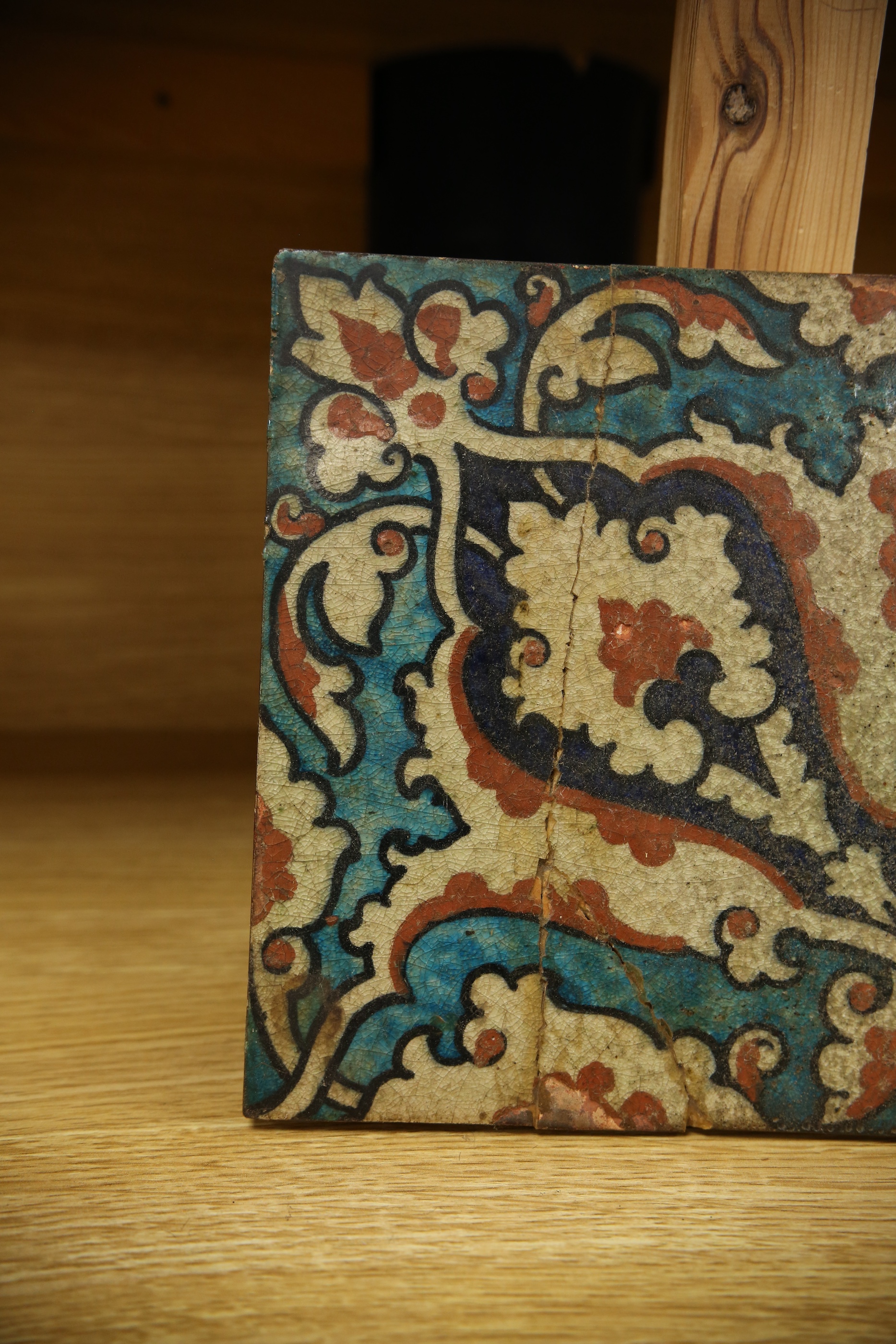 A 17th century style Iznik pottery tile, 20.5cm sq. Condition - poor